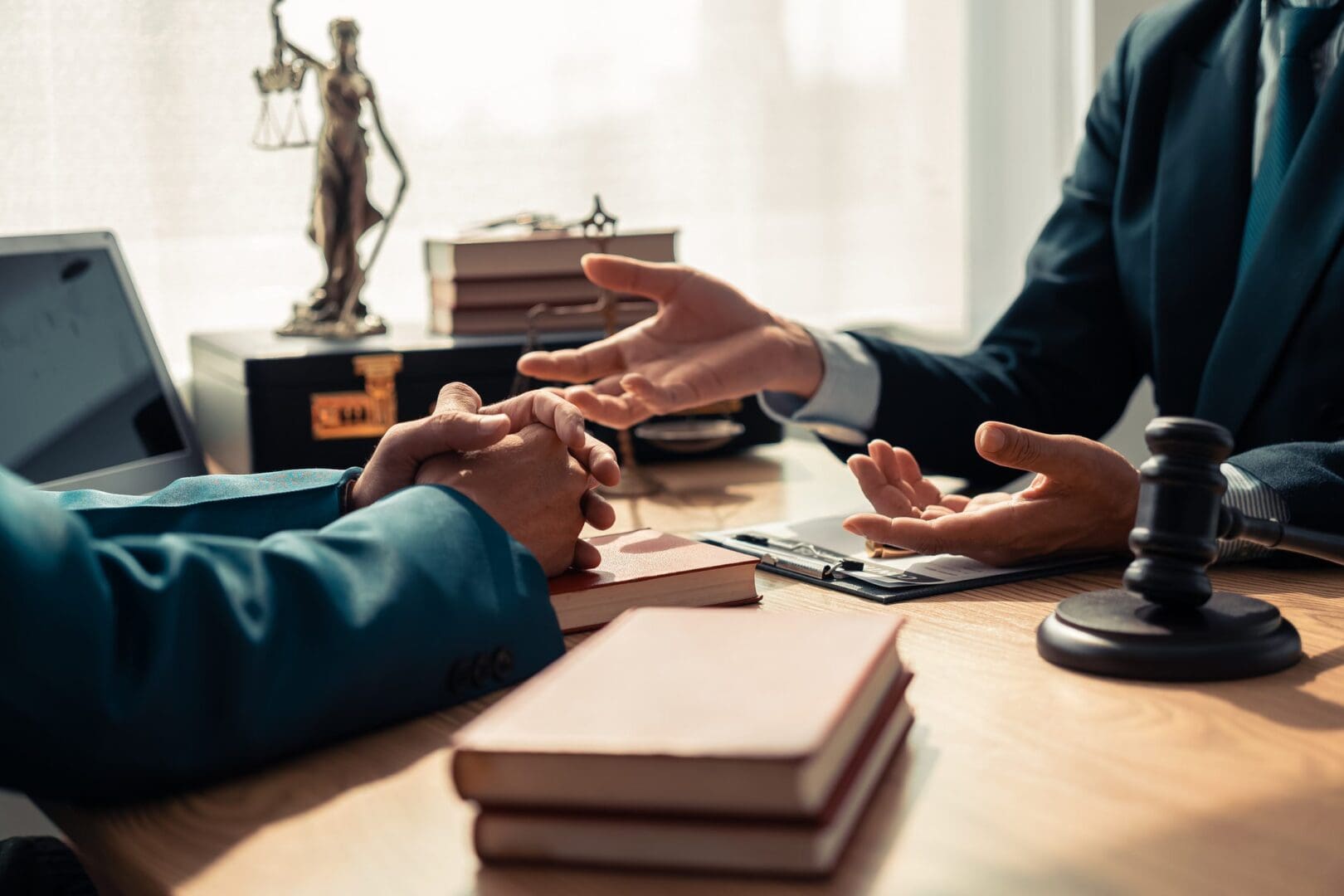 Two people discussing documents in a professional office setting.